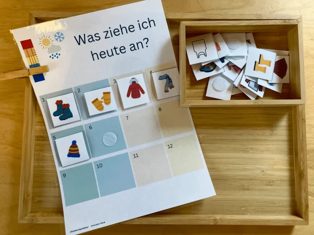Anziehplan „Was ziehe ich heute an?“ mit Bildkarten in einer Holzkiste