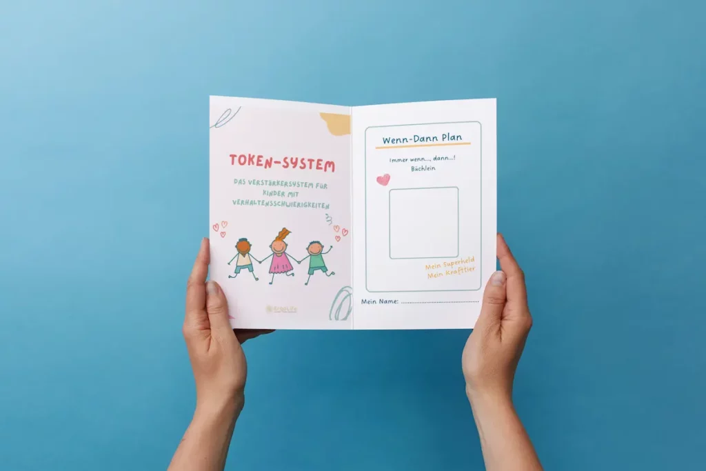 Hände halten das Token-System und den Wenn-Dann-Plan vor blauem Hintergrund